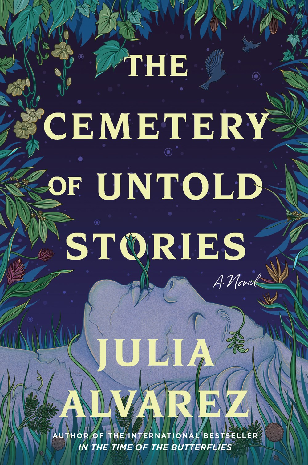 Book cover for The Cemetery of Untold Stories, featuring a dark background and a forested area, with a gray stone statue laying on the ground. We just see the head of the statue, facing up into the leafy darkness. The title of the book is in yellow block lettering.